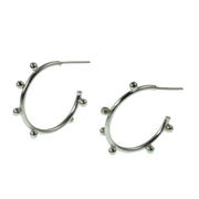 Large silver hoop earrings with 7 silver balls on each hoop. They're made of eco silver and are all handmade.