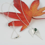 Eco silver necklace featuring two different sized leaves which have given a real leaf texture. The larger leaf features a Moss Agate gemstone which sits on it like a rain drop after a shower. The back of the leaves have a shiny mirror finish.
