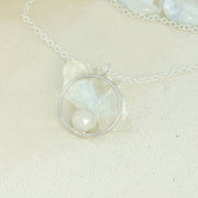 Silver pendant necklace featuring a hoop with a gemstone in inside at the bottom. The gemstone measures 8mm in diameter. This pendant features an Moonstone Rose cut cabochon gemstone, other options are available.