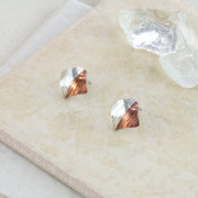 Square stud earrings, half in copper and the other half in silver. They have a round mirror finish and come in a stripe hammered mirror finish too. They're 10mm by 10mm in size.