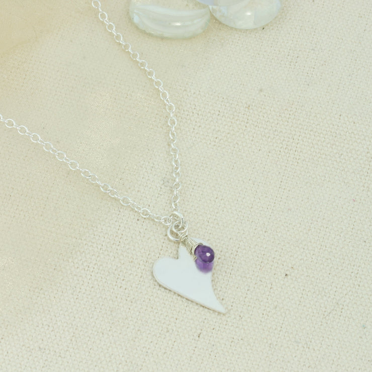 Silver personalised heart pendant necklace with Amethyst briolette gemstone.  The heart is approximately 2 x 1.5 cm in diameter  with a larger version of 1.5 x 2cm available as well and can be personalised with a word, initials, letter or symbols. The briolette gemstones is attached to the same jump ring as the pendant, so they sit together. The necklace can be fastened at three different lengths at 40cm, 45cm and 50cm.