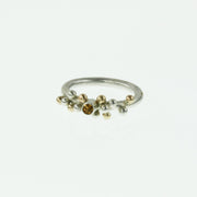 Eco silver ring with silver and 9ct gold balls at the top, with a Citrine gemstone in in the middle. The gemstone is 3mm in diameter and the ring has a matte finish.
