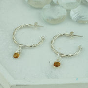Silver hoop earrings featuring two twisted wires, with briolette gemstones. Classic hoop earrings, featuring a shiny polished finish. Shown here on combined with the Citrine briolette gemstones. Separate gemstones to add to your collection are available as well.