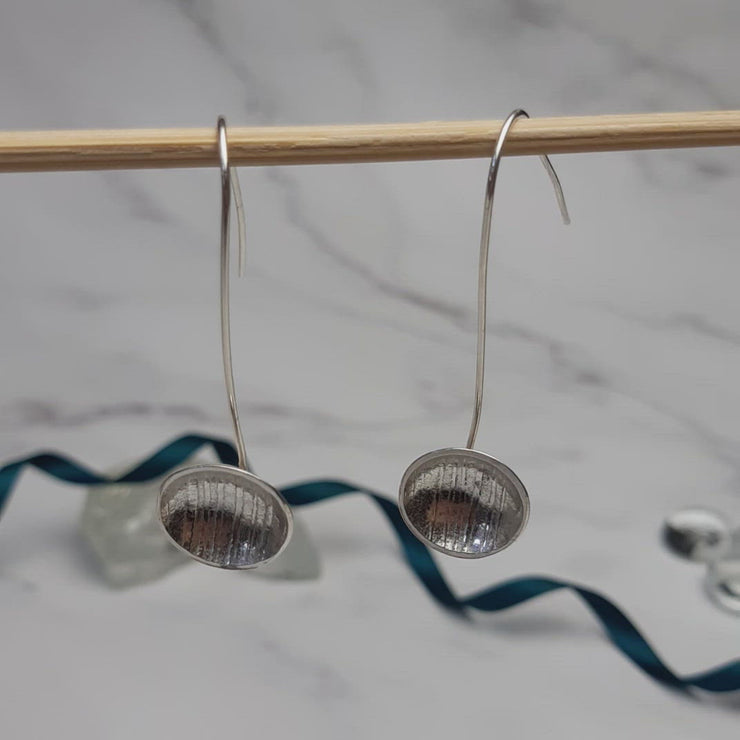 Eco silver drop cup earrings. The drop hook and cup are made from eco silver. The cup has been given a stripe texture and a mirror finish.