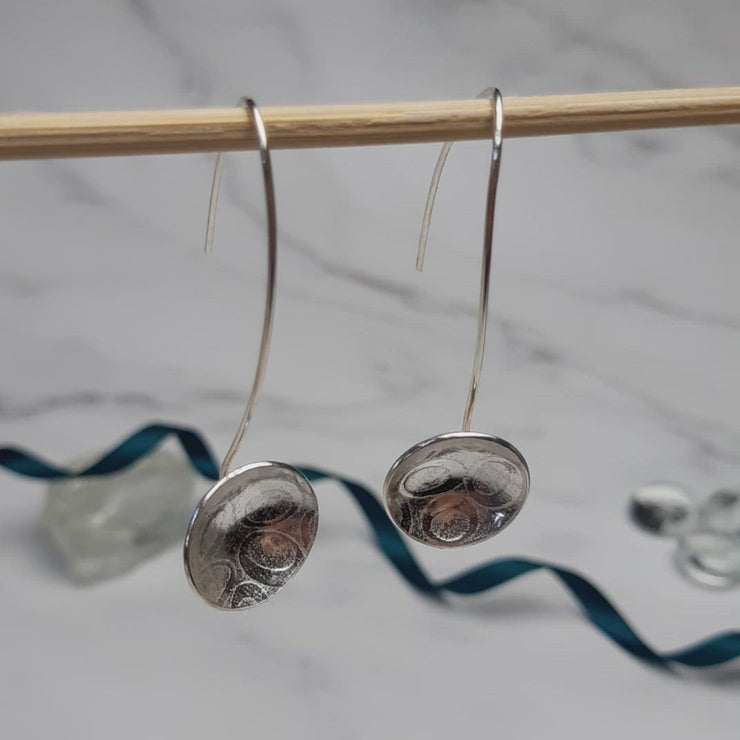Eco silver drop cup earrings. The drop hook and cup are made from eco silver. The cup has been given a pebble texture and a mirror finish.