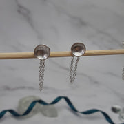 Eco silver small domed cups with a stripe or pebble texture. A chain is attached to the cup with a jump ring at the bottom. A jump ring is attached to the end of the chain to loop the stud through and fasten behind it with the silver scroll. These cups have a stripe or pebble texture.