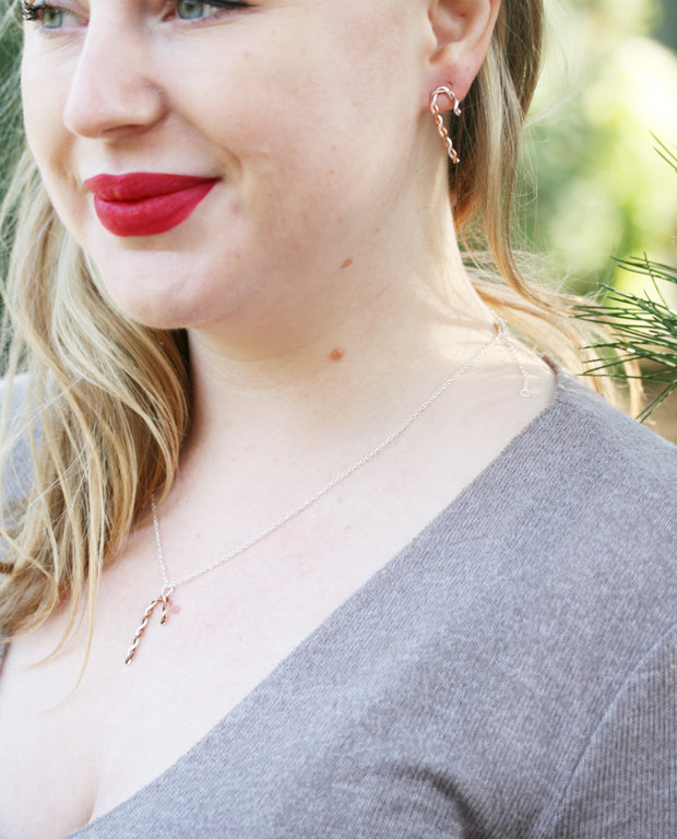 Silver and copper stud earrings. Silver and copper wire has been twisted around each other and shaped into a candy cane shape. Available in two sizes and a matching pendant necklace is also available.