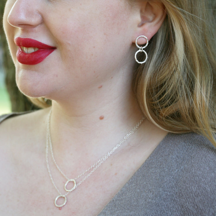 Silver double hoop multi strand necklace. Both hoops have a hammered shiny finish to let the light bounce of and give them a sparkly finish.