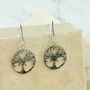 Eco silver Tree of life hook earrings. The Tree of life hangs from a 20mm hook. Both the front of the hook and the Tree of life have a hammered and oxidised darker finish. Full of symbolism for new beginnings and growth.