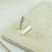 Eco silver bar stud earrings. These earrings are made from square silver wire that has been given a square hammered texture and a shiny finish.