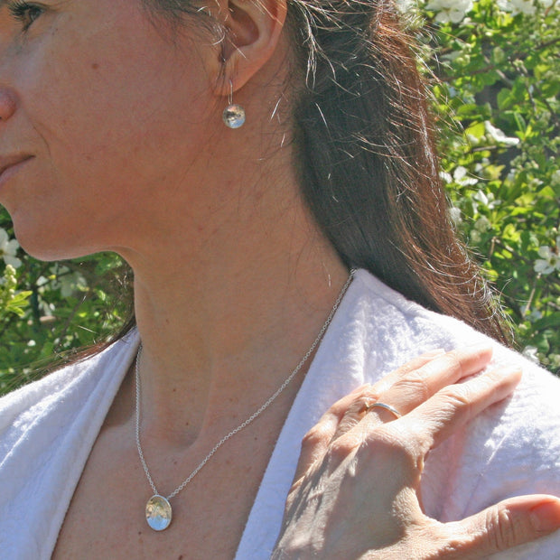 Eco silver pendant necklace and drop necklace with a pebble texture and mirror finish.