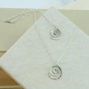 Silver multi strand swirl necklace. Two swirls feature this necklace with two strands. The swirls have a hammered shiny finish and fasten with a lobster clasp.