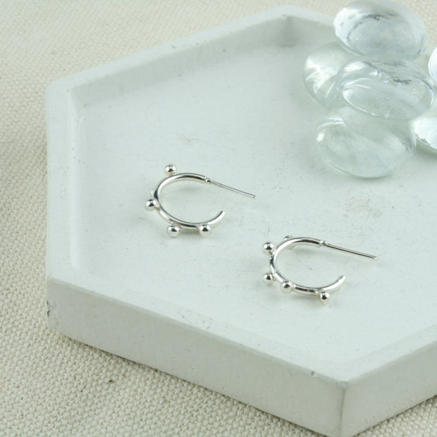 Silver hoop stud earrings featuring 5 silver balls. Available in three sizes these are the smallest at 13mm / 0.5" in diameter. These are handmade hoops made form eco-silver. 