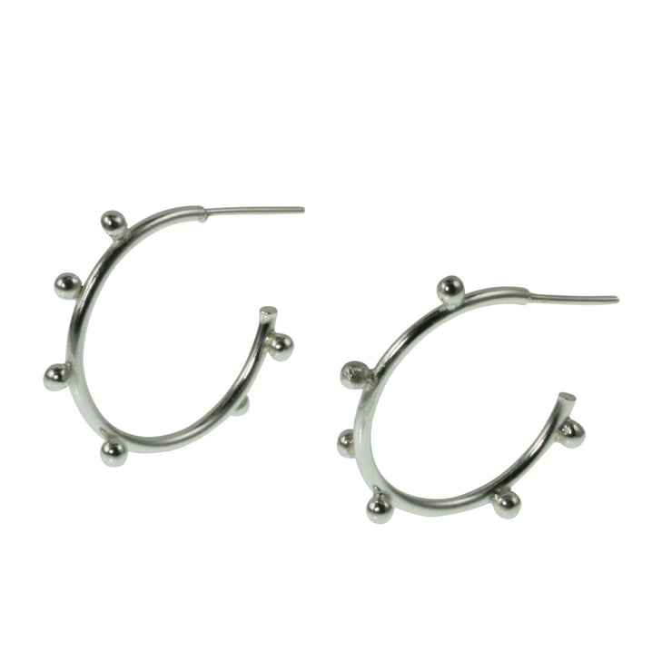 Large silver hoop earrings with 7 silver balls on each hoop. They&