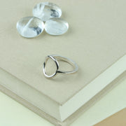 Eco silver ring featuring a square ring band and a round hoop. It has a shiny mirror finish.