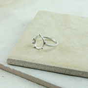 Eco silver ring featuring a square ring band and a round hoop. Spread around the hoop are 6 silver balls to add a fun fresh touch to the ring. It has a shiny mirror finish.
