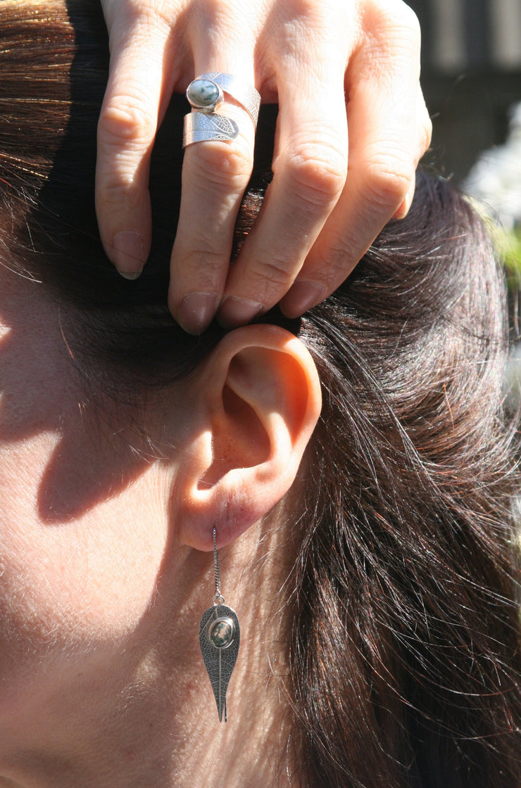 Eco silver thread earrings featuring a leaf shape with a Moss Agate gemstone at the top. The leaves have a real leaf texture and the Moss Agate gemstone is set with an opening in the back to let the light shine through for stunning effect.