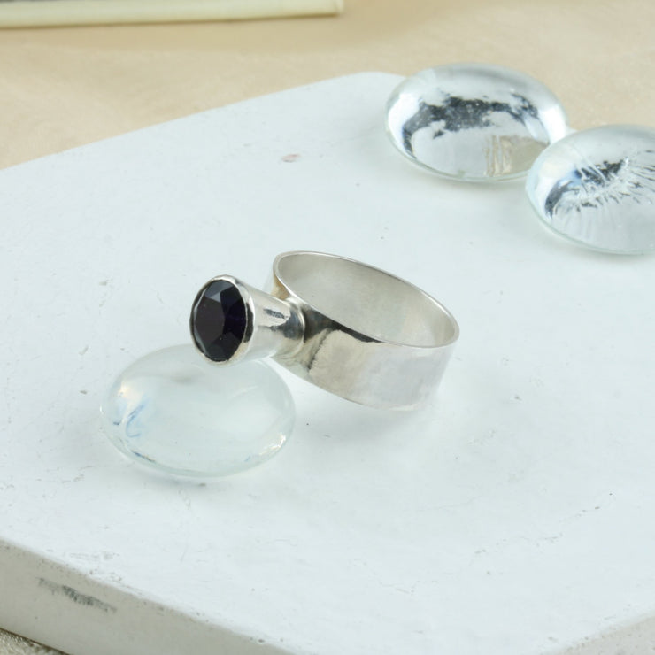 Eco silver ring band with an Amethyst gemstone in a collet setting. The ring has a mirror finish and the collet setting elevates the gemstone to sit about 10mm / 0.4" above the ring band.