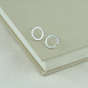 Silver shiny hoop stud earrings, flat hoops with a hammered and shiny finish. 