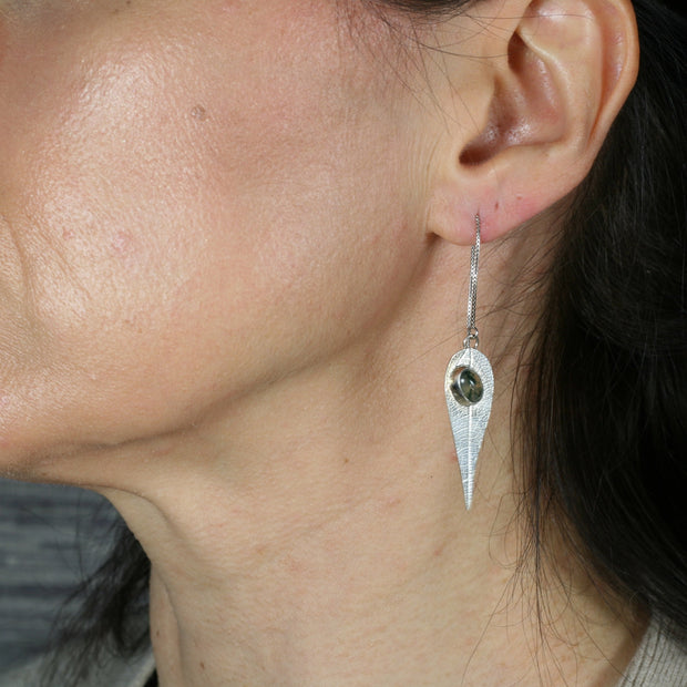 Eco silver thread earrings featuring a leaf shape with a Moss Agate gemstone at the top. The leaves have a real leaf texture and the Moss Agate gemstone is set with an opening in the back to let the light shine through for stunning effect. 