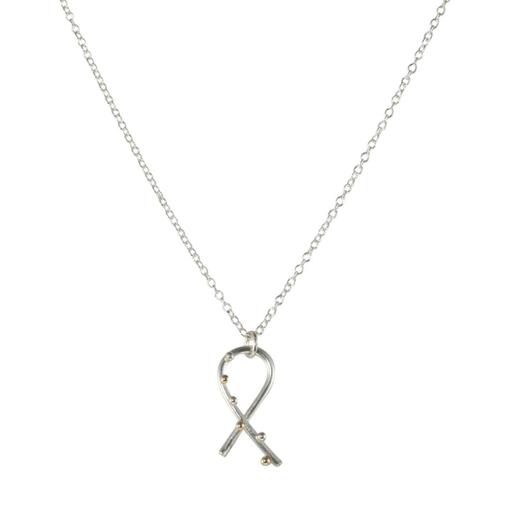 Silver pendant necklace featuring a twirl shape. Three 9ct gold and three silver balls are featured to one side at the front. The pendant has a shiny mirror finish and the necklace can be fastened at two different lengths.