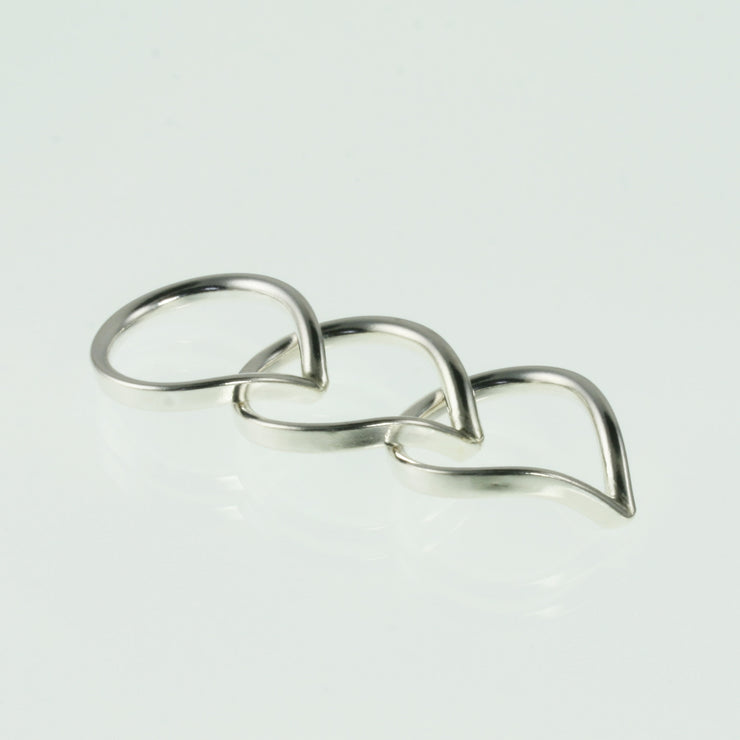 Eco silver wishbone rings. This ring is made using D shaped wire with the curve on the inside and the flat side on the outside. The rich dips into a V-shape on one side. This  design is beautiful on its own and in combination with a gemstone ring allowing space to wrap around it.