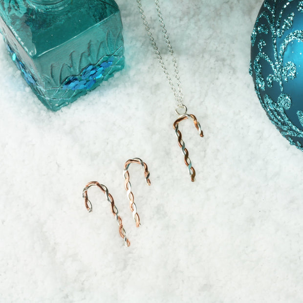 Silver and copper stud earrings. Silver and copper wire has been twisted around each other and shaped into a candy cane shape. Available in two sizes and a matching pendant necklace is also available.