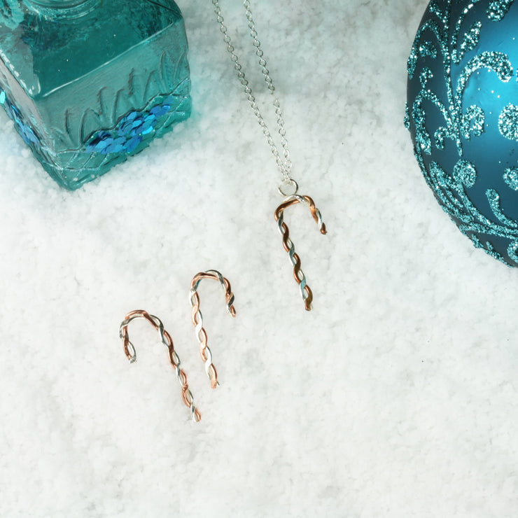 Silver and copper pendant necklace featuring a candy cane shape made from copper and silver wire that has been twisted around each other. Available in two sizes and seen here with the matching stud earrings.