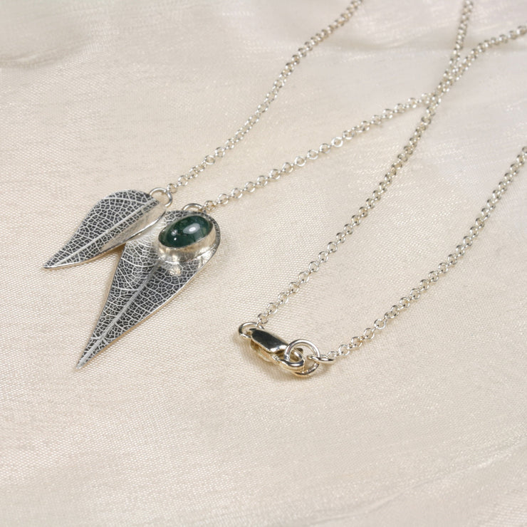 Eco silver necklace featuring two different sized leaves which have given a real leaf texture. The larger leaf features a Moss Agate gemstone which sits on it like a rain drop after a shower. The back of the leaves have a shiny mirror finish.