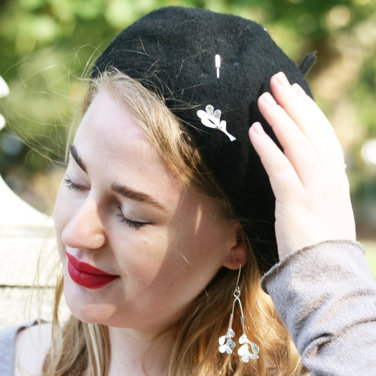 Silver pin featuring a Mistletoe shape with five small leaves and three berries at the top. It is 3.5 x 2 cm in size and the 5cm long pin at the back comes with a pin protector to pop onto the sharp end. All polished to a mirror finish, with a striped hammered texture on the front of the leaves. Lovely on a hat, scarf, or jacket.