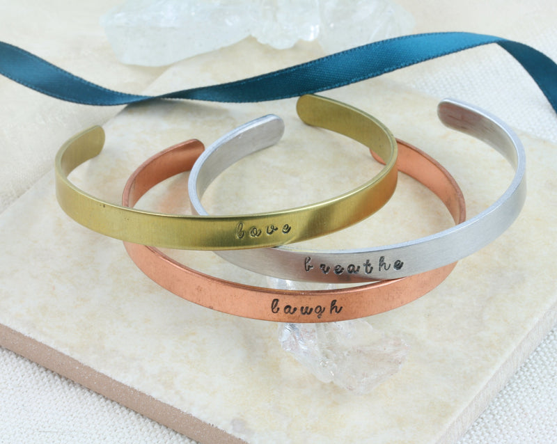 Personalised brass, aluminium and copper bangle bracelets.