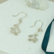 Silver hook earrings featuring Mistletoe with a silver ball as a berry. The leaves have a striped texture and a shiny silver finish. The total drop is 2.5cm from the hook.