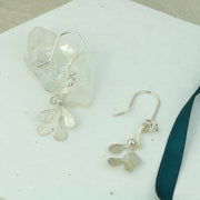 Silver hook earrings featuring Mistletoe with a silver ball as a berry. The leaves have a striped texture and a shiny silver finish. The total drop is 2.5cm from the hook.