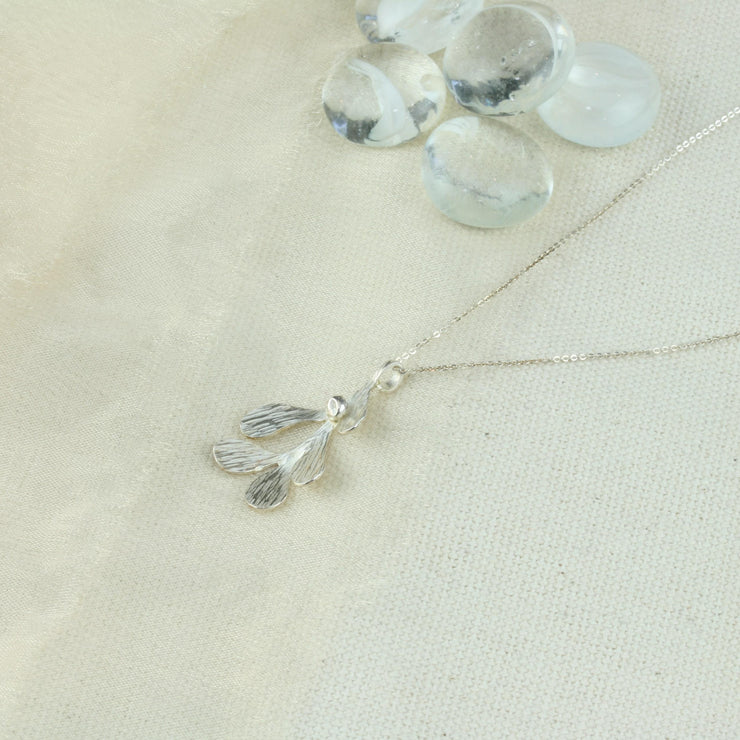 Silver Mistletoe pendant necklace. This necklace can be worn at two different lengths and features a Mistletoe pendant with five textured leaves and a silver berry at the top of the leaf.