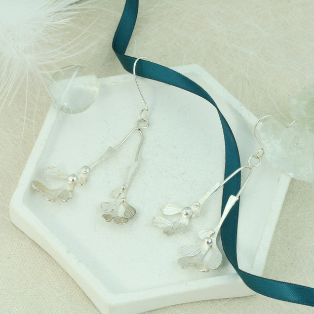 Silver drop earrings featuring two Mistletoe branches with silver balls as berries. Both branches are attached to asilver hook and the total drop is 6.5cm from the hook.