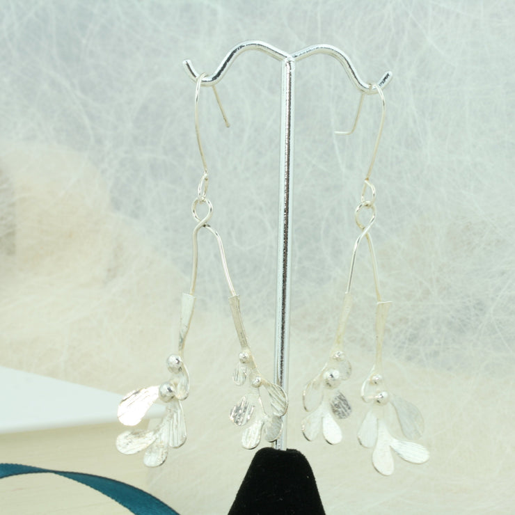 Silver drop earrings featuring two Mistletoe branches with silver balls as berries. Both branches are attached to asilver hook and the total drop is 6.5cm from the hook.