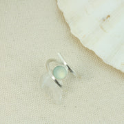 Silver twisted ring made from square eco silver wire. In between the two sides sits a Blue Chalcedony rose cut gemstone. All the different facets make this shimmer and shine when it catches the light. 