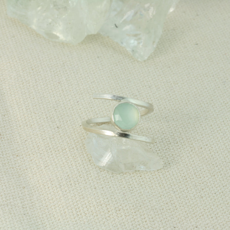 Silver twisted ring made from square eco silver wire. In between the two sides sits a Blue Chalcedony rose cut gemstone. All the different facets make this shimmer and shine when it catches the light.