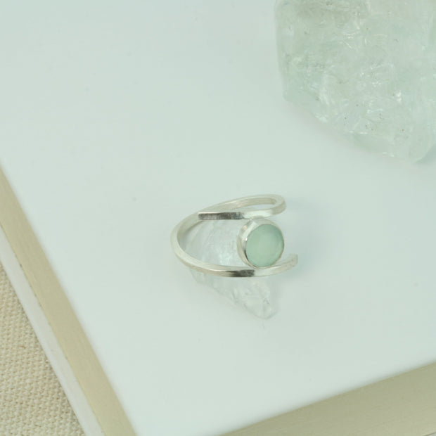 Silver twisted ring made from square eco silver wire. In between the two sides sits a Blue Chalcedony rose cut gemstone. All the different facets make this shimmer and shine when it catches the light. 