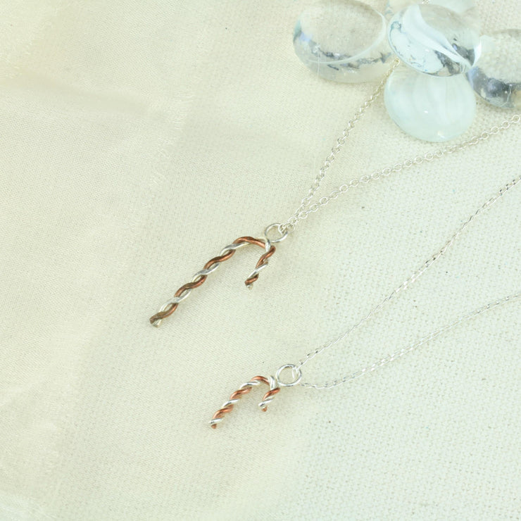 Silver and copper pendant necklace featuring a candy cane shape made from copper and silver wire that has been twisted around each other. Available in two different sizes, both shown here.