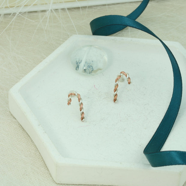 Silver and copper stud earrings. Silver and copper wire has been twisted around each other and shaped into a candy cane shape. Available in two sizes and a matching pendant necklace is also available.