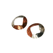 Large stud earrings with copper and silver. A large circle shape with a square diamond shape sawn out of the centre.  One side is made in copper the other in silver. Available with two textures, a striped texture and a round circle texture.