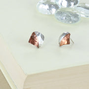 Square stud earrings, half in copper and the other half in silver. They have a round mirror finish and come in a stripe hammered mirror finish too. They're 10mm by 10mm in size.