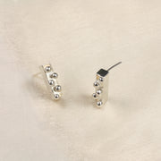 Eco silver bar stud earrings featuring five silver balls on the front side. These earrings have a mirror finish and a matching pendant necklace is available to make a set.