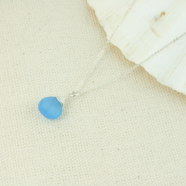 Silver pendant necklace featuring a Blue Chalcedony faceted heart gemstone which has been wire wrapped into a pendant. The delicate silver necklace can be worn at two different lengths.