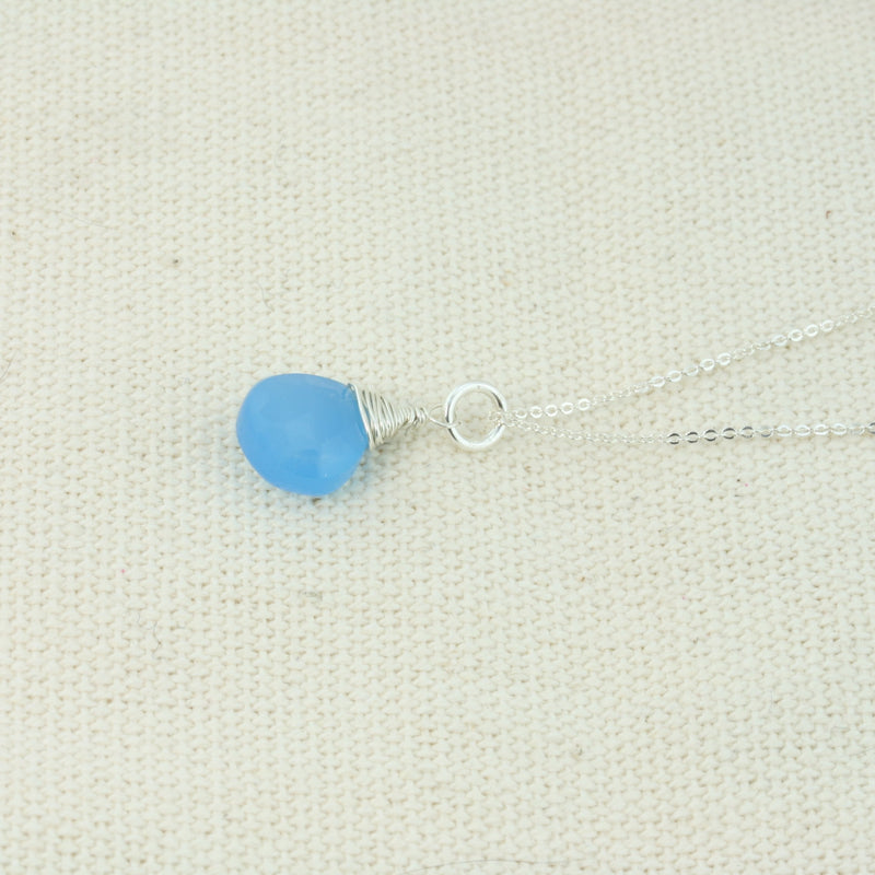 Silver pendant necklace featuring a Blue Chalcedony faceted heart gemstone which has been wire wrapped into a pendant. The delicate silver necklace can be worn at two different lengths.