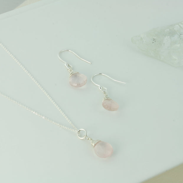 Silver briolette earrings featuring Rose Quartz faceted teardrop gemstones. The facets point at different angles catching the light perfectly for a bit shimmer and shine. They are wrapped with eco silver wire and dangle from silver earrings hooks. Paired here with the matching Silver briolette pendant necklace.