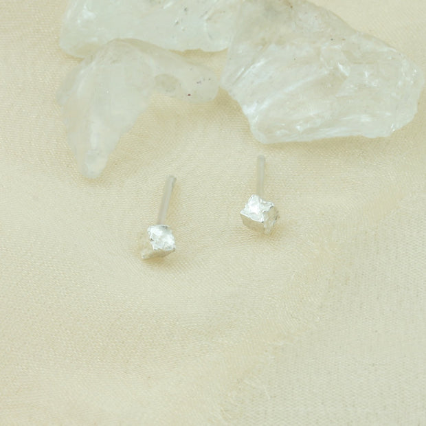 Silver cube stud earrings, featuring a hammered and shiny finish to make them sparkle. Made using eco silver.
