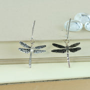 Silver hook earrings in the shape of a dragonfly. The front has a textured finish with the wings also oxidised for a darker look. A great combination with the dragonfly pendant necklace.