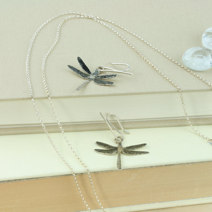 Silver hook earrings in the shape of a dragonfly. The front has a textured finish with the wings also oxidised for a darker look. A great combination with the dragonfly pendant necklace.